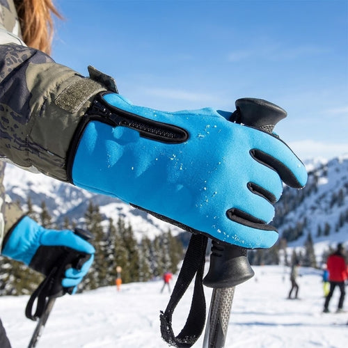 Skier holding ski poles in blue touch screen zipper gloves on a snowy mountain