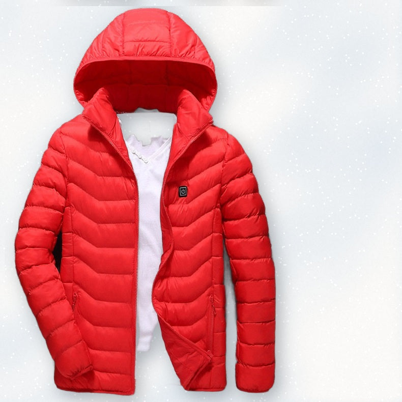Red USB heated jacket with hood laid on fresh snow