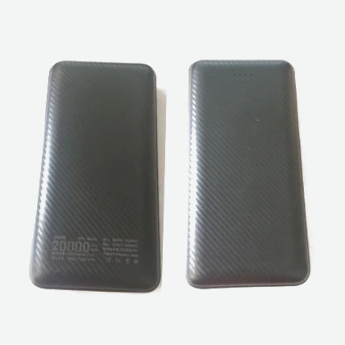 Two slim black USB power banks with a carbon-fiber texture